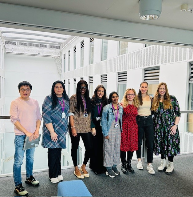 A group of academic researchers stand together facing the camera, smiling. The KOKU team.