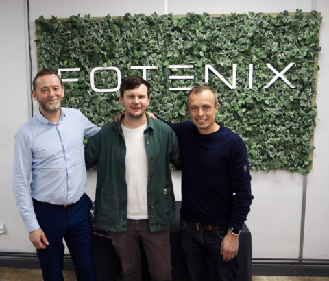 3 men standing and smiling at the camera against a backdrop that reads 'FOTENIX'